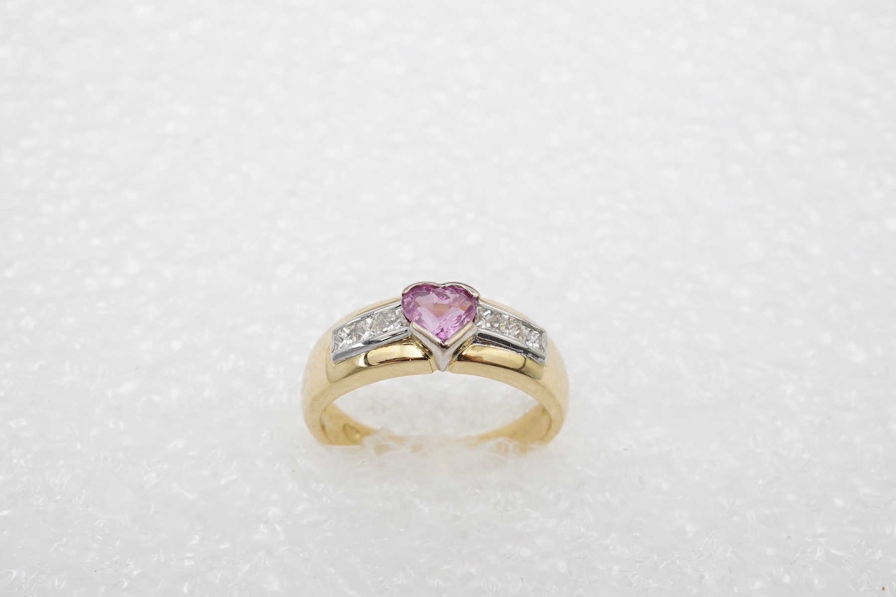 A pink sapphire and diamond ring